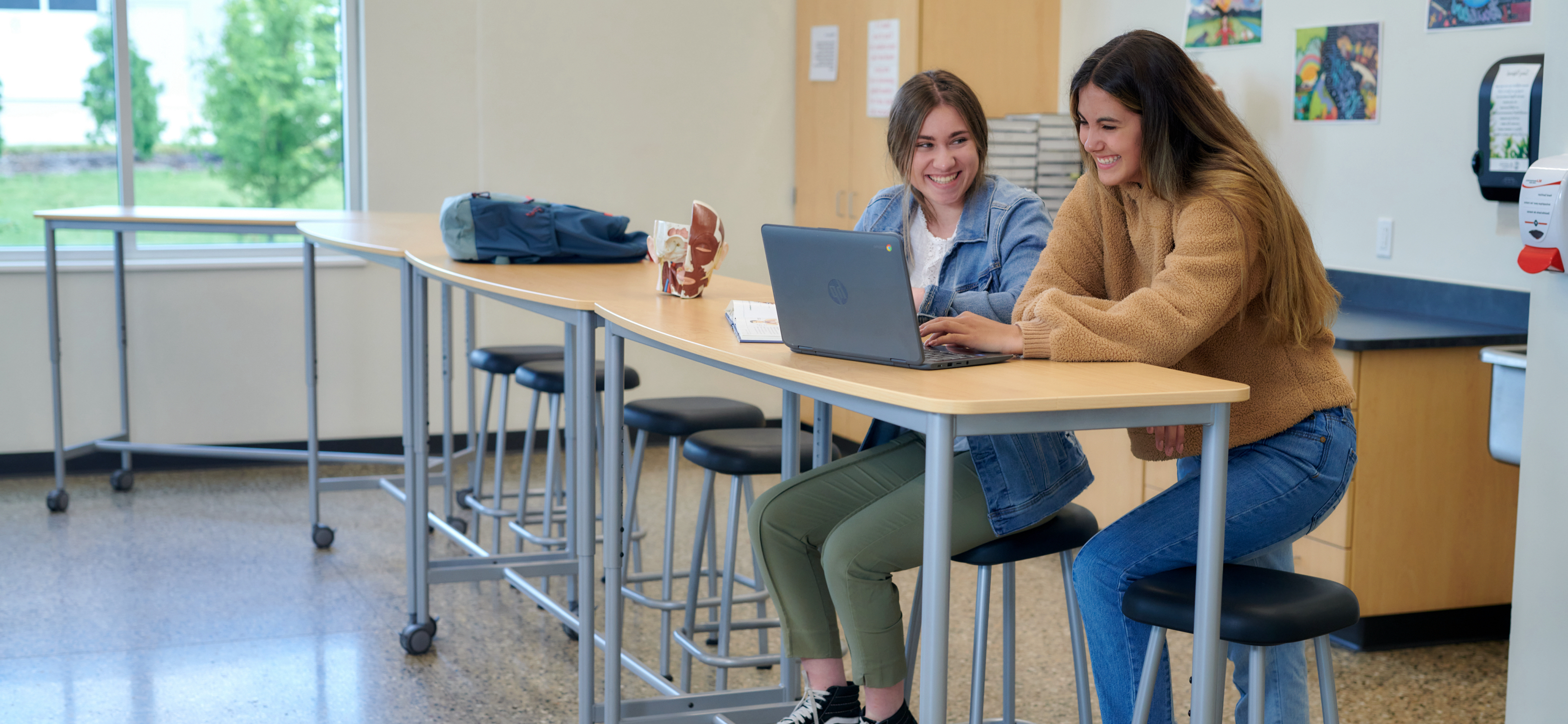 Students using laptop at table
