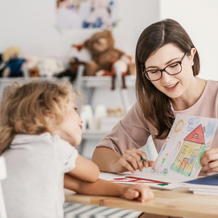 A woman reading a book to a young girl
