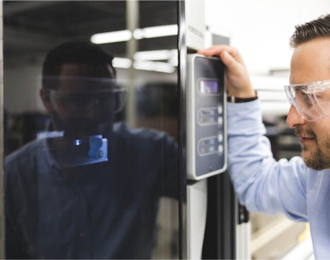 Electronics worker looking at machine